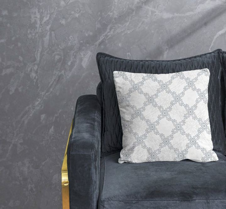 Patterned cushion on a velvet armchair