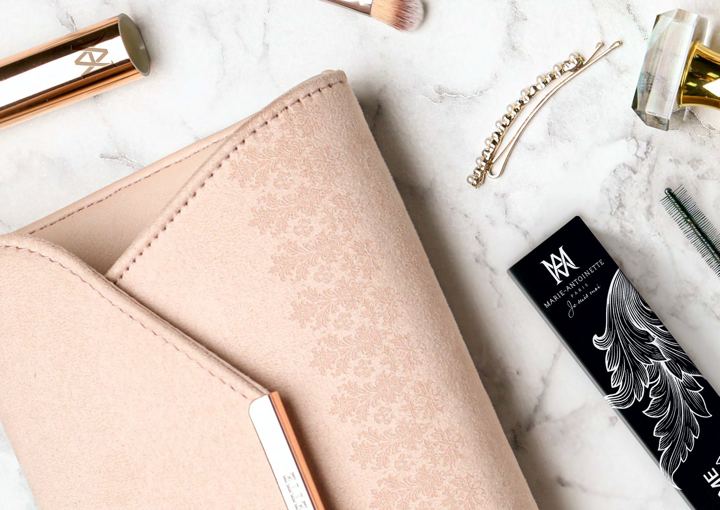 Blush-pink wallet with gold hardware